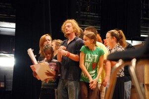 Acting a scene from Act 2 in “Willy Wonka,” the characters crowd together to fit in a cramped space. Pictured left to right: Lizz Redpath, theater major; Corie Matthews; Noah Mowry, theater major; and Sarah Kent. 