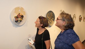 ClayHouston art students Nell Gottlieb and Cindy Butler Rasche admire Torres's work. 