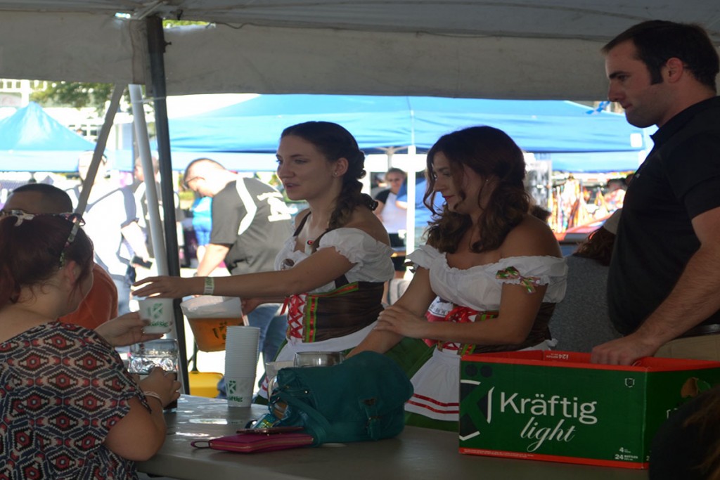 The Kraftig girls hand out beer samples to festivalgoers at the Kemah Oktoberfest. Photo by The Signal Reporter Jaclynn Abatecola