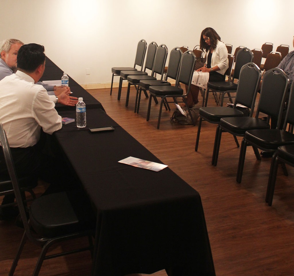 PHOTO: The Signal reporter Erika Sanchez sitting in on an empty mayoral debate at The Printing Museum with the only candidate who showed up – Nguyen Thai Hoc. Photo by The Signal reporter Alyx Haraway.