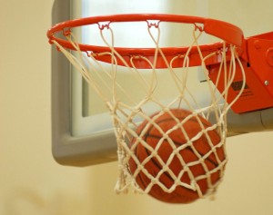Photo: Basketball falling through net.