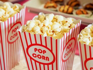 Photo: Red and white striped bucket filled with popcorn. Courtesy image. Source: Pixabay.com.