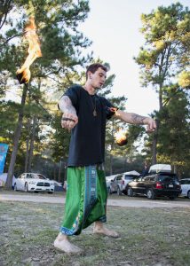 A performer using fire poi while wearing amazing pants. Photo courtesy of Regan Bjerkeli, communication major.