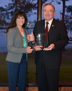 Photo: University of Houston-Clear Lake President William A. Staples, right, presents UHCL’s 2017 Community Partnership Award to Denise S. Navarro, founder and President/CEO of Clear Lake-based Logical Innovations Inc. The company created an endowment to fund UHCL’s Hawk Advantage Scholarship program, which provides need-based financial aid for incoming freshman. The presentation was made at Staples’ annual Report to the Community at the Lakewood Yacht Club on March 16.