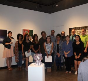 The 20 featured audience show off their work at the BFA Exhibition at the UHCL Art Gallery. Photo by The Signal reporter Donada Fortner.