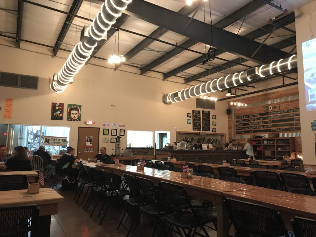 Saloon Door Brewing's interior showcases the rustic-Texas look with corrugated metal paneling and rope lights wrapped around the exposed ductwork. Photo by the Signal Reporter, Alex Petty.