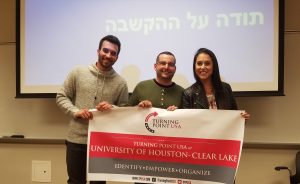(from left to right) Itamar, IDF reservist;Jesse Stock, Texas associate director of SWU,; and Kayla, IDF reservist , holding the UHCL TPUSA banner. Photo by The Signal reporter Erica Bernal .
