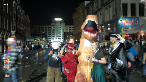 The Signal Editor-in-Chief Liz Davis with T-Rex and Mardi Gras! Galveston attendees on The Strand. Photo courtesy of Lauren Rayne, literature major.