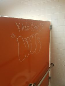 Graffiti in Bayou Building's men's restroom displaying the word, "nine."