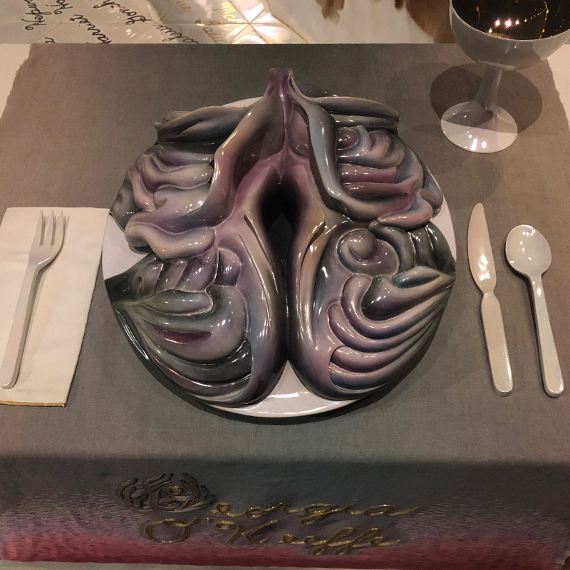 PHOTO: Photo of Georgia O'Keeffe's place at Judy Chicago's "The Dinner Party" installation at the Brooklyn Museum. O'Keeffe was one of a handful of women with place settings that was living at the time of its creation. Place setting features a large mauve plate with a vaginal opening. Photo courtesy of The Signal Advisor Lindsay Humphrey.