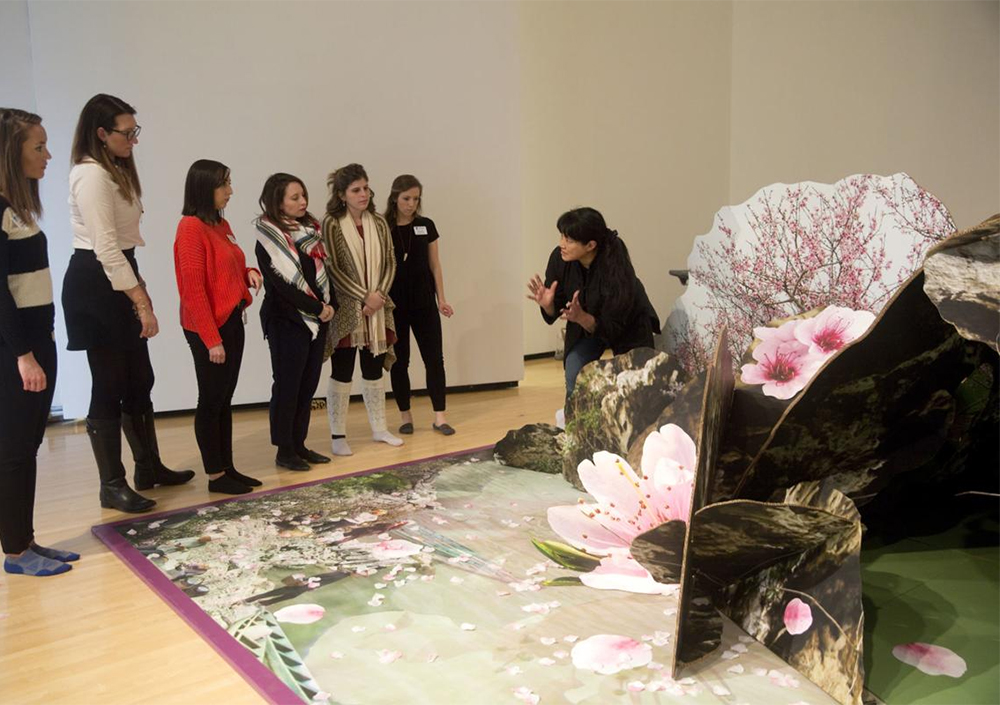 PHOTO: Fu is showing staff of the Taubman Museum in Roanoke, Virginia how to handle installations of her large pop-up books. Photo courtesy of Stephanie Klein-Davis.
